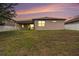 A large backyard with a view of the house at dusk at 1512 Banner Elk St, Valrico, FL 33594