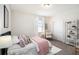 A cozy bedroom featuring a stylish bed, white linens, and a plush pink throw at 1512 Banner Elk St, Valrico, FL 33594