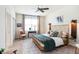 A well-lit bedroom featuring a unique wooden bed frame, ceiling fan, and a stylish accent chair at 1512 Banner Elk St, Valrico, FL 33594