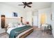 Bright bedroom showcasing a unique wooden bed frame, stylish furniture, and ample natural light at 1512 Banner Elk St, Valrico, FL 33594