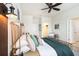 Inviting bedroom featuring a wooden bed frame with decorative pillows and views of the ensuite at 1512 Banner Elk St, Valrico, FL 33594