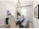 Formal dining room with stylish light fixture, seating for six, and sheer window curtains at 1512 Banner Elk St, Valrico, FL 33594