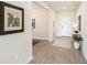 Inviting foyer with stylish wood floors, white walls, and elegant decorative accents at 1512 Banner Elk St, Valrico, FL 33594