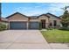 Charming single-story home featuring a three-car garage and beautifully landscaped front yard at 1512 Banner Elk St, Valrico, FL 33594