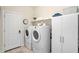 This functional laundry room features plenty of storage space and machines at 1512 Banner Elk St, Valrico, FL 33594