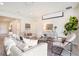 Bright living room featuring neutral paint, stylish furniture, a projection screen, and ample natural light at 1512 Banner Elk St, Valrico, FL 33594