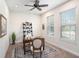 Cozy office with a wooden desk, neutral tones, and natural light from large windows at 1512 Banner Elk St, Valrico, FL 33594