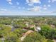 An aerial view of the neighborhood showing lush landscaping and nearby residences at 160 Sage Cir, Crystal Beach, FL 34681
