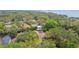An aerial view of the property showcasing a screened-in pool and lush landscaping at 160 Sage Cir, Crystal Beach, FL 34681