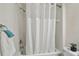 Bathroom with toilet, tile shower and white shower curtain at 160 Sage Cir, Crystal Beach, FL 34681
