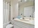 Bright bathroom with white cabinets, sink, toilet, and shower at 160 Sage Cir, Crystal Beach, FL 34681