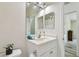 Bright bathroom featuring a vanity, large mirror with lights, and neutral wall paint at 160 Sage Cir, Crystal Beach, FL 34681