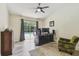 Bedroom with a ceiling fan, sliding glass doors and desk at 160 Sage Cir, Crystal Beach, FL 34681