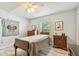 Neutral bedroom featuring wood-look floors, light walls, ceiling fan, and window views at 160 Sage Cir, Crystal Beach, FL 34681