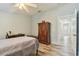 Bright bedroom featuring wood-look floors and entry to the connected bathroom at 160 Sage Cir, Crystal Beach, FL 34681