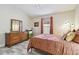 Comfortable bedroom with a ceiling fan, wood-look floors, and plenty of natural light at 160 Sage Cir, Crystal Beach, FL 34681