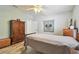 Bright bedroom featuring wood-look floors, a ceiling fan, and a comfortable bed at 160 Sage Cir, Crystal Beach, FL 34681