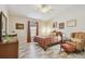Cozy bedroom features a ceiling fan, wood-look floors, and neutral paint at 160 Sage Cir, Crystal Beach, FL 34681