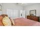 Well-lit bedroom offers a ceiling fan, wood-look floors, and closet at 160 Sage Cir, Crystal Beach, FL 34681