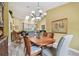 Open dining room with chandelier lighting and views to the living room at 160 Sage Cir, Crystal Beach, FL 34681