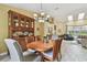 Inviting dining room features a wood table, hutch, and modern chandelier, creating an ideal space for gatherings and meals at 160 Sage Cir, Crystal Beach, FL 34681
