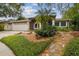 Charming home featuring an arched entry, manicured landscaping, and a convenient two-car garage at 160 Sage Cir, Crystal Beach, FL 34681