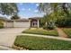 Charming single-story home with a well-manicured front yard, arched entry, and a convenient two-car garage at 160 Sage Cir, Crystal Beach, FL 34681