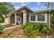 A landscaped entry with double doors under columned arches and a large window at 160 Sage Cir, Crystal Beach, FL 34681