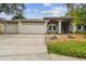 Traditional home with a well-maintained lawn and two-car garage at 160 Sage Cir, Crystal Beach, FL 34681