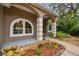 Inviting front porch showcasing potted plants and a welcoming arched entryway at 160 Sage Cir, Crystal Beach, FL 34681