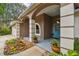 Front porch with light blue doors, columned arches, and xeriscaping at 160 Sage Cir, Crystal Beach, FL 34681