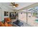 This covered lanai features modern furniture, an outdoor kitchen, and a view of the screened-in pool at 160 Sage Cir, Crystal Beach, FL 34681
