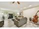 Spacious living room featuring wood-look floors, comfortable seating, and natural light at 160 Sage Cir, Crystal Beach, FL 34681