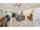 Spacious living room featuring wood-look floors, ceiling fan, comfortable seating, and natural light at 160 Sage Cir, Crystal Beach, FL 34681