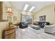 Bright living room with comfortable seating and view to outdoor pool area at 160 Sage Cir, Crystal Beach, FL 34681