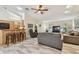 Spacious living room with breakfast bar featuring wood-look floors, ceiling fan and natural light at 160 Sage Cir, Crystal Beach, FL 34681