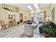 Sunlit living room featuring vaulted ceilings, skylights, and sliding glass doors at 160 Sage Cir, Crystal Beach, FL 34681