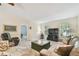 Cozy living room featuring plush sofas, a unique coffee table, and bright windows for natural light at 160 Sage Cir, Crystal Beach, FL 34681