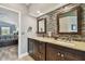 Main bathroom with double sinks, granite countertops, and a stylish mosaic backsplash at 160 Sage Cir, Crystal Beach, FL 34681