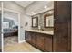 Main bathroom with double sinks, mosaic tile accent wall, granite countertops, and tile flooring at 160 Sage Cir, Crystal Beach, FL 34681