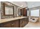 The main bathroom features double sinks, mosaic tiles, granite countertops and a soaking tub at 160 Sage Cir, Crystal Beach, FL 34681