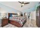 Cozy main bedroom featuring a ceiling fan, neutral paint and wood-look floors at 160 Sage Cir, Crystal Beach, FL 34681