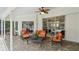 Relaxing screened-in patio with modern furniture, ceiling fan, and a view of the pool and backyard at 160 Sage Cir, Crystal Beach, FL 34681