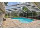 Beautiful screened-in pool with paver deck, and landscaping. Great for entertaining and outdoor living at 160 Sage Cir, Crystal Beach, FL 34681