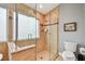 Shower featuring glass enclosure, frosted window, tiled walls, and recessed niche at 160 Sage Cir, Crystal Beach, FL 34681