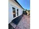 A backyard with French doors and a patio space surrounded by a wooden fence at 1778 New Hampshire Ne Ave, St Petersburg, FL 33703