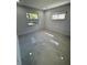 Bedroom with tiled floors and windows at 1778 New Hampshire Ne Ave, St Petersburg, FL 33703