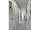 Hallway featuring marble tile flooring and white doors with black hardware leading to various rooms at 1778 New Hampshire Ne Ave, St Petersburg, FL 33703