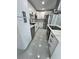 Modern kitchen features stainless appliances, white cabinets, and a quartz countertop island at 1778 New Hampshire Ne Ave, St Petersburg, FL 33703