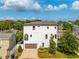 Three-story home with tile roof, balcony, two-car garage, landscaping, and long driveway at 2110 W Azeele St, Tampa, FL 33606